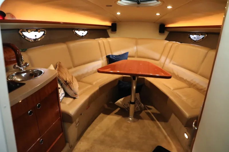Slide: The Image of Interior of 2006 Cobalt 323 boat with beige leather seating and wooden table. - 11