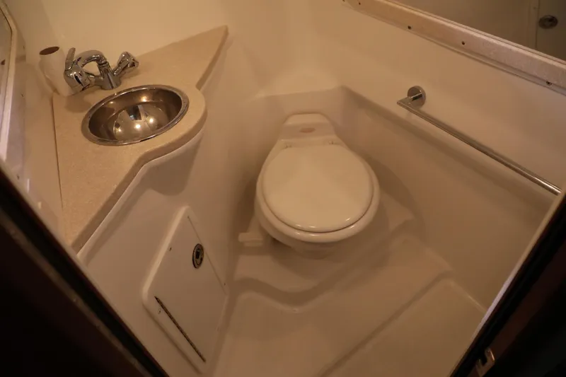 Slide: The Image of Compact bathroom in a 2006 Cobalt 323 boat with sink and toilet. - 14