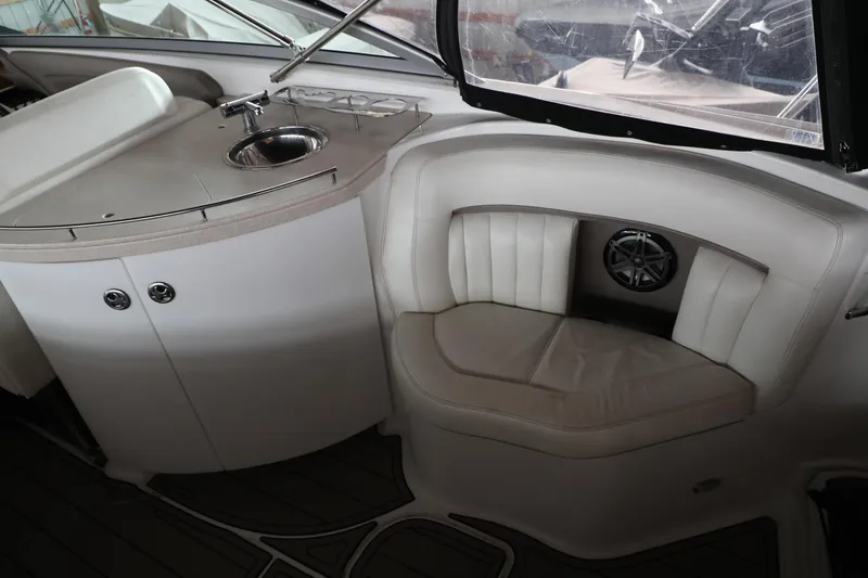 Slide: The Image of Interior of a 2006 Cobalt 323 boat with a sink and cushioned seating area. - 16