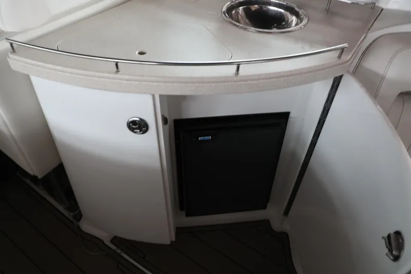 Slide: The Image of 2006 Cobalt 323 boat interior with sink and mini fridge. - 17