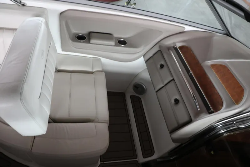 Slide: The Image of Interior of a 2006 Cobalt 323 boat with white leather seating and wood accents. - 6
