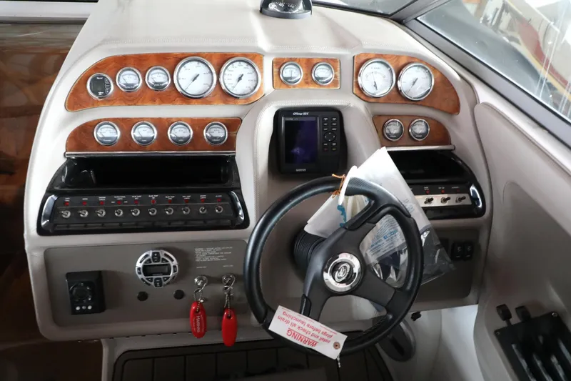 Slide: The Image of 2006 Cobalt 323 boat dashboard with gauges, steering wheel, and control panel. - 7