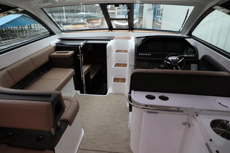 Slide: The Image of Interior of a 2016 Cobalt A40 boat with seating, helm, and cabin access. - 12