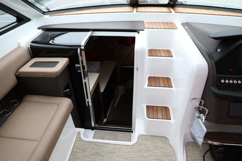 Slide: The Image of Interior of 2016 Cobalt A40 boat showing cabin entrance, seating, and steps. - 13