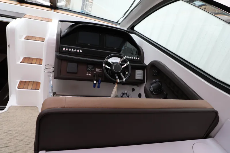Slide: The Image of Interior helm of 2016 Cobalt A40 boat with modern controls and steering wheel. - 14