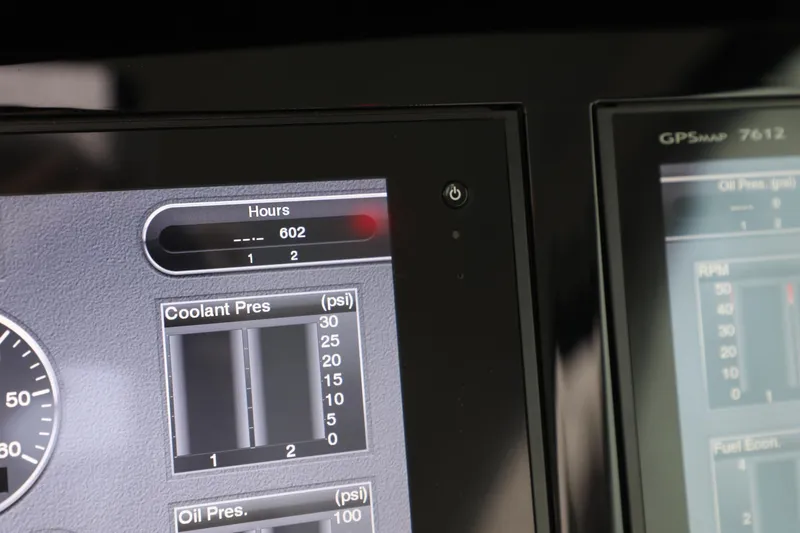 Slide: The Image of Close-up of 2016 Cobalt A40 boat dashboard displaying engine hours and coolant pressure. - 16