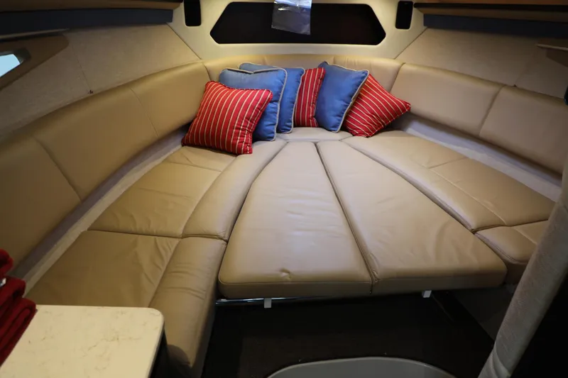 Slide: The Image of Luxurious 2016 Cobalt A40 boat interior with beige leather seating and colorful pillows. - 19