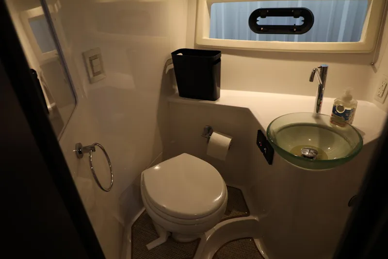 Slide: The Image of Compact bathroom in a 2016 Cobalt A40 boat with modern fixtures and a glass sink. - 20