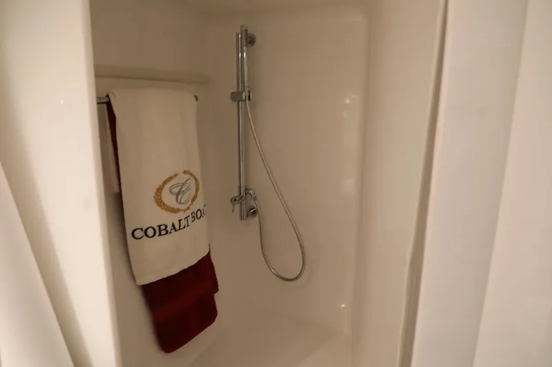 Slide: The Image of Shower area in 2016 Cobalt A40 boat with branded towel and chrome showerhead. - 21