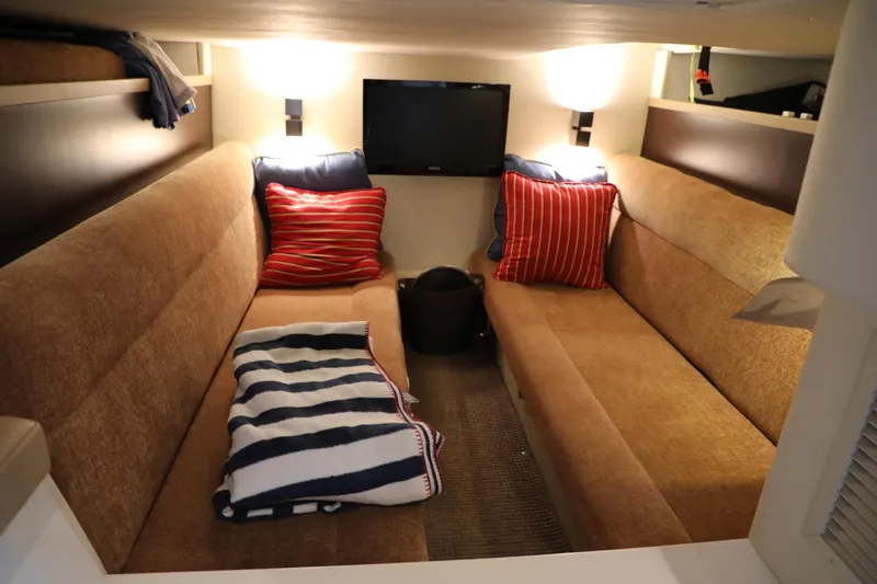 Slide: The Image of Interior cabin of 2016 Cobalt A40 boat with cozy seating and striped pillows. - 22