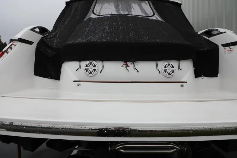 Slide: The Image of Rear view of a 2016 Cobalt A40 boat with black cover and speakers. - 3