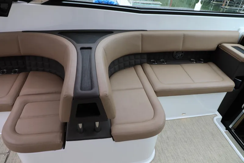 Slide: The Image of 2016 Cobalt A40 boat interior with beige leather seating and cup holders. - 6