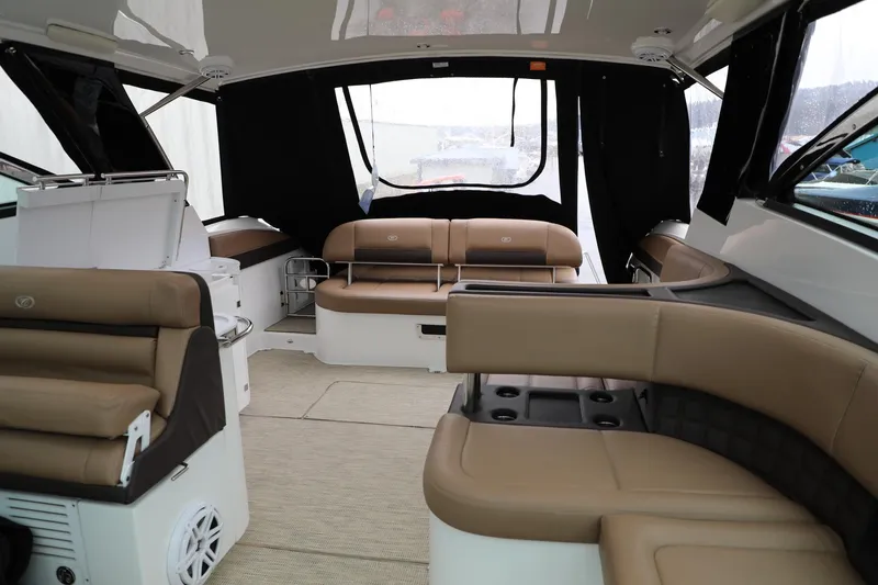 Slide: The Image of Interior of a 2016 Cobalt A40 boat with tan leather seating and modern amenities. - 7
