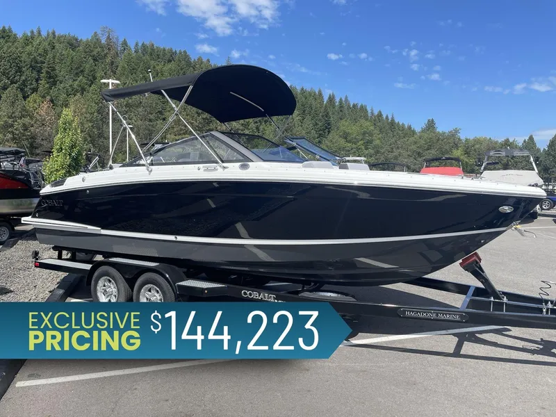 Slide: The Image of 2024 Cobalt R4 boat on trailer, exclusive pricing $144,223, forested background. - 1