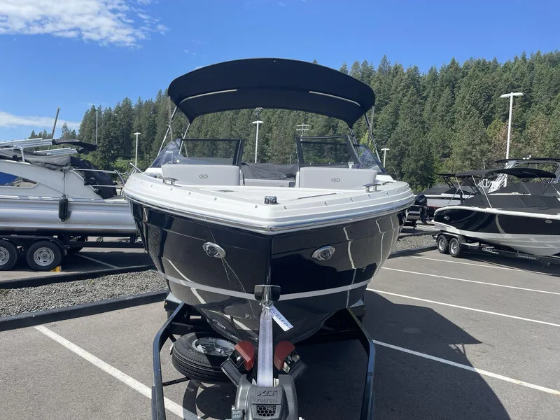 Slide: The Image of 2024 Cobalt R4 boat on trailer, parked outdoors under clear blue sky. - 3