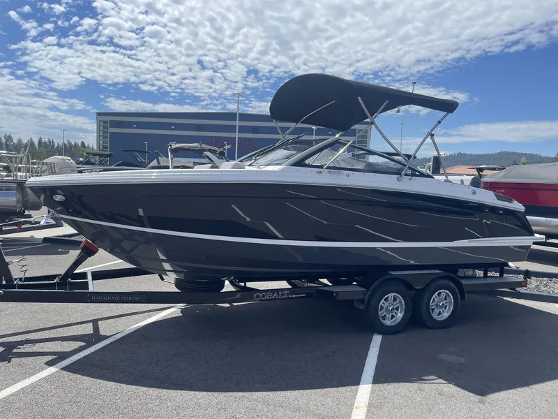 Slide: The Image of 2024 Cobalt R4 boat on trailer under clear sky, side view. - 4