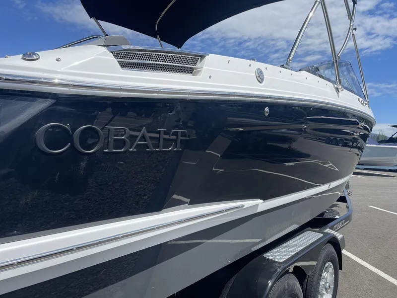 Slide: The Image of 2024 Cobalt R4 boat on trailer under clear blue sky. - 5
