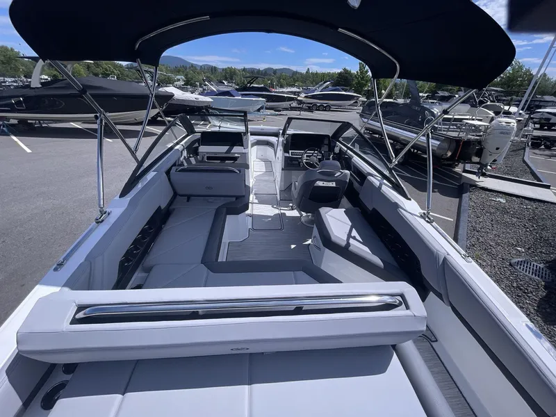 Slide: The Image of 2024 Cobalt R4 boat interior with spacious seating and sleek design under a canopy. - 7