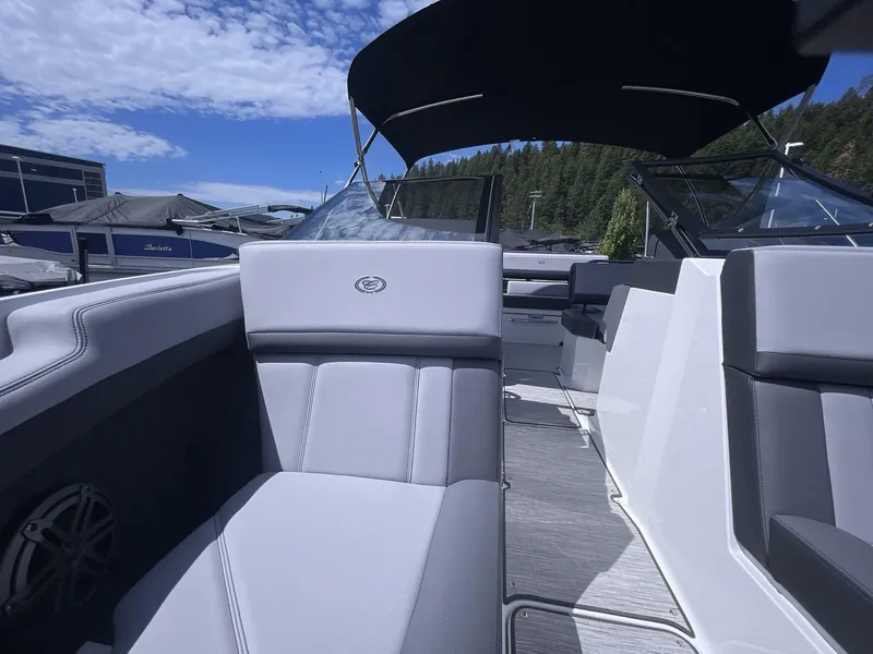Slide: The Image of 2024 Cobalt R4 boat interior with sleek seating and canopy under a blue sky. - 9