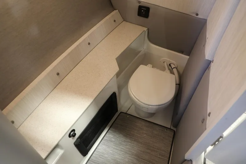 Slide: The Image of 2024 Cobalt R8 boat interior bathroom with modern fixtures and compact design. - 10
