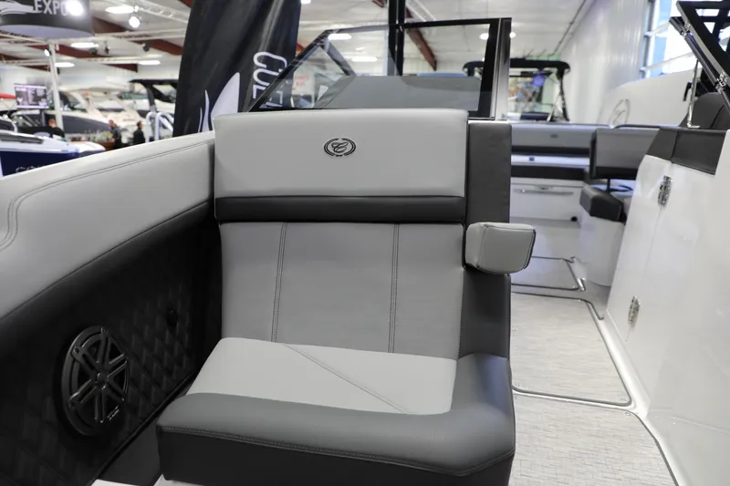 Slide: The Image of 2024 Cobalt R8 boat interior with gray and black seating, speaker, and armrest. - 5