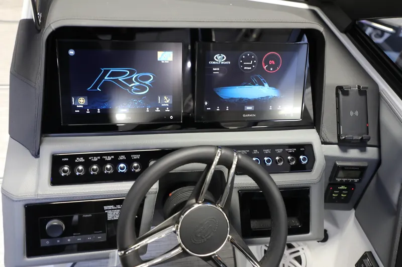 Slide: The Image of 2024 Cobalt R8 boat dashboard with dual Garmin displays and control panel. - 8