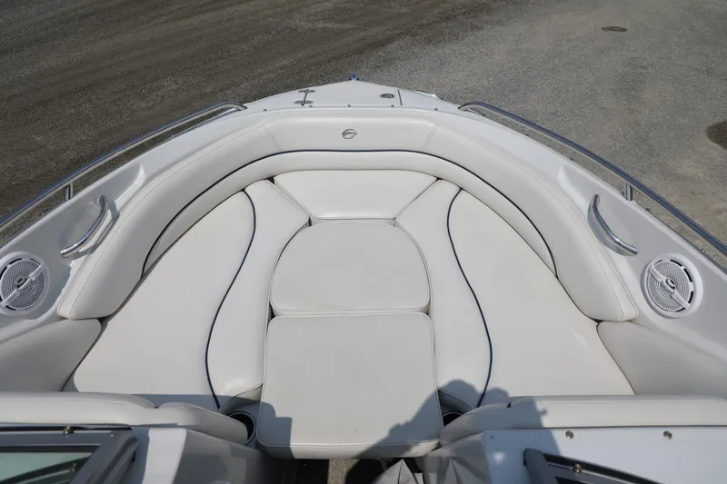 Slide: The Image of 2010 Crownline 220 LS boat interior with white cushioned seating and speakers. - 10