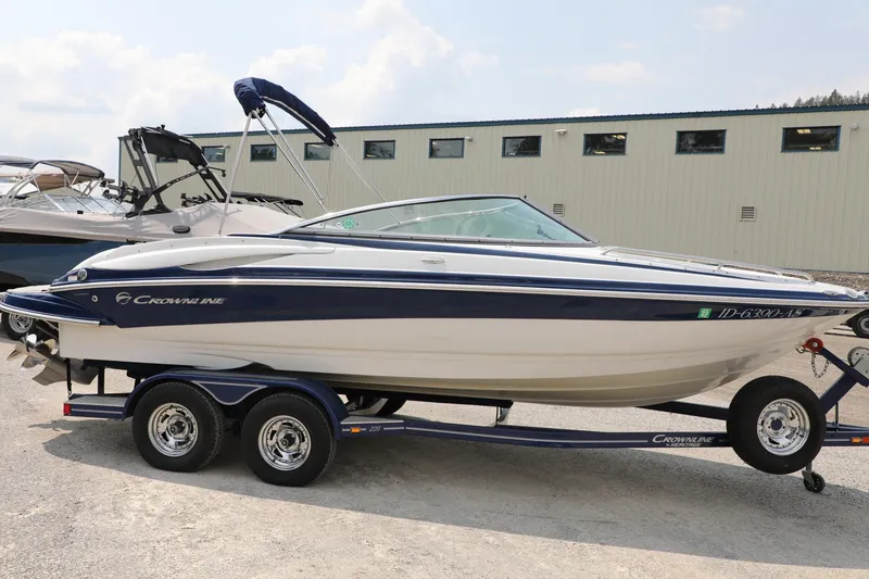 Slide: The Image of 2010 Crownline 220 LS boat on trailer, parked outdoors. - 3