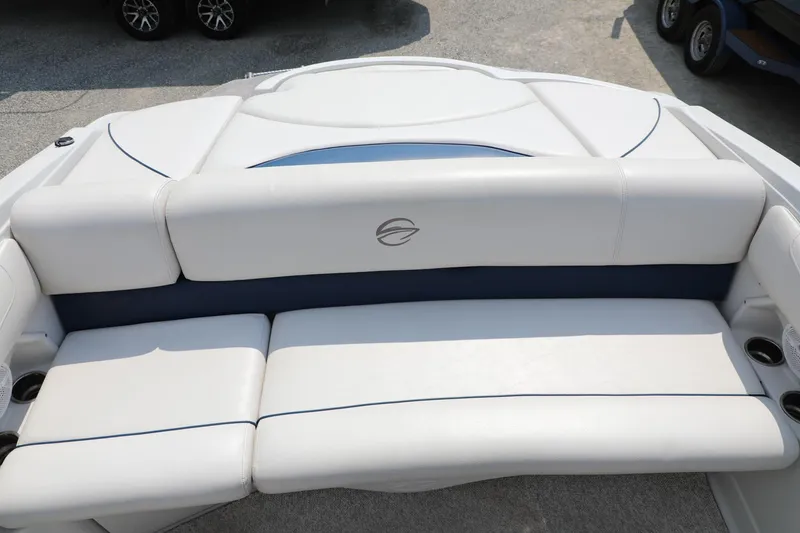 Slide: The Image of 2010 Crownline 220 LS boat with white cushioned seating and cup holders. - 5