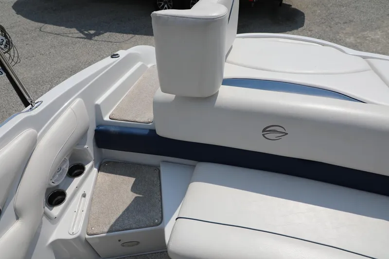 Slide: The Image of 2010 Crownline 220 LS boat interior with white and blue seating, cup holders, and logo. - 6