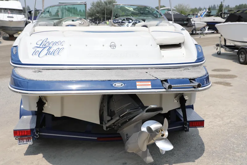Slide: The Image of 2010 Crownline 220 LS boat with "License to Chill" text, rear view. - 8