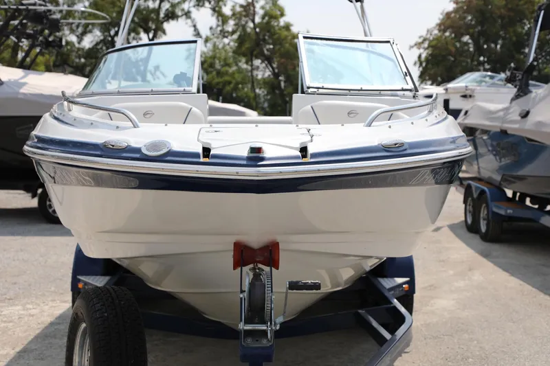 Slide: The Image of 2010 Crownline 220 LS boat on trailer, front view, outdoors. - 9