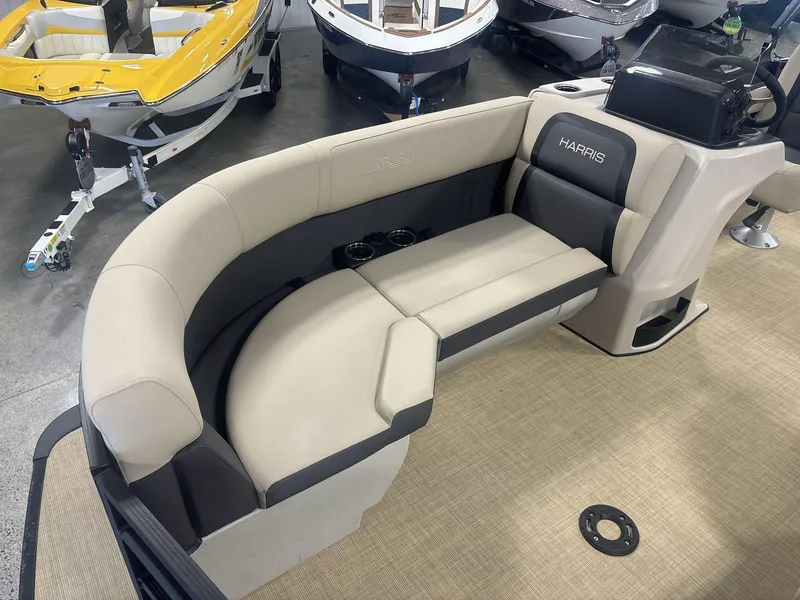 Slide: The Image of 2024 Harris Cruiser 210 boat interior with beige seating and cup holders. - 10