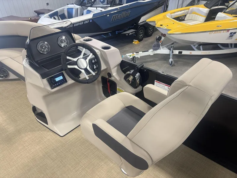Slide: The Image of 2024 Harris Cruiser 210 boat interior with steering console and seating. - 12
