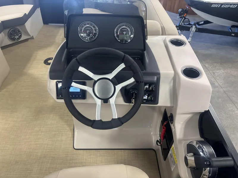 Slide: The Image of 2024 Harris Cruiser 210 dashboard with steering wheel and gauges. - 13