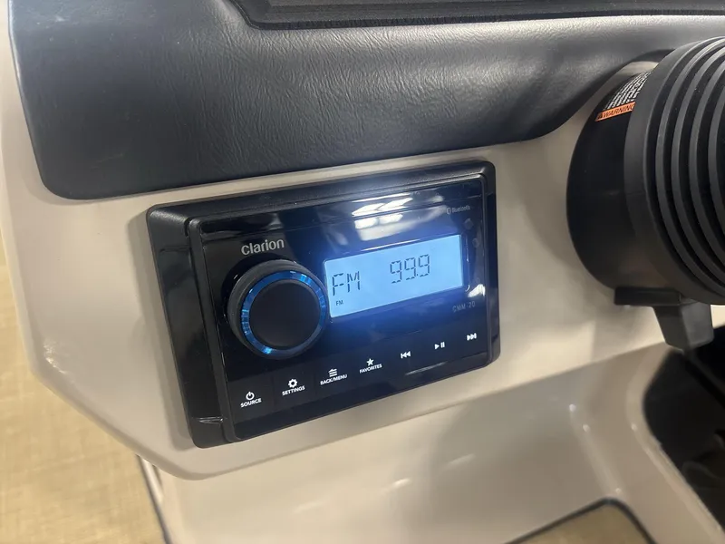 Slide: The Image of Clarion radio display in 2024 Harris Cruiser 210, tuned to FM 99.9. - 14