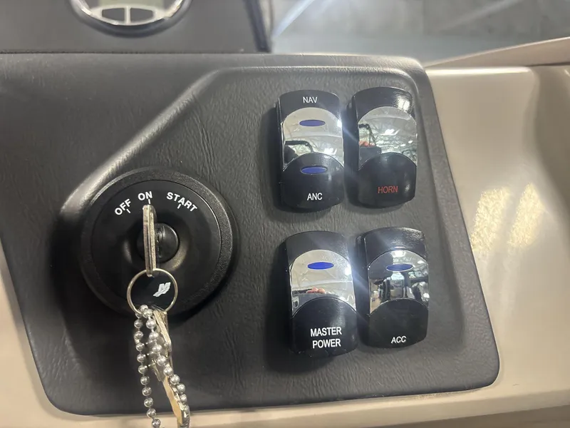 Slide: The Image of Control panel of 2024 Harris Cruiser 210 with ignition and switches. - 16