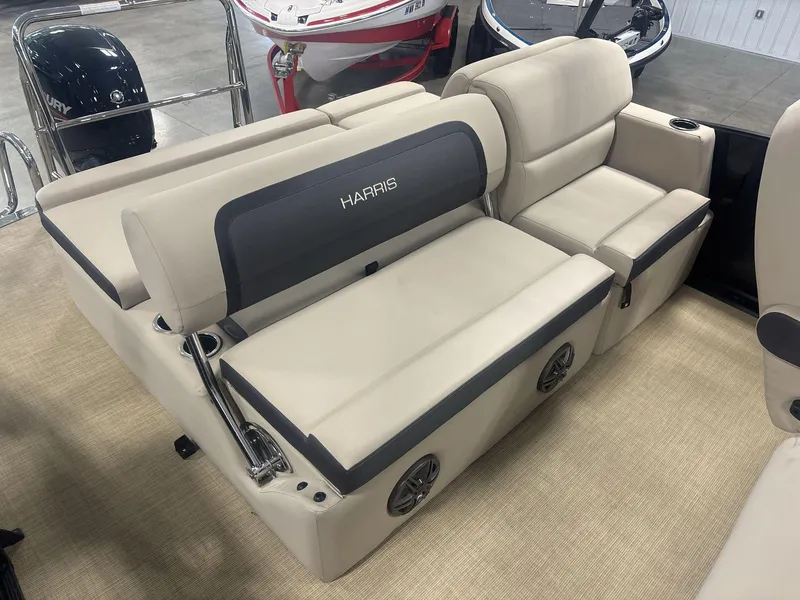 Slide: The Image of 2024 Harris Cruiser 210 boat interior with beige seating and cup holders. - 17