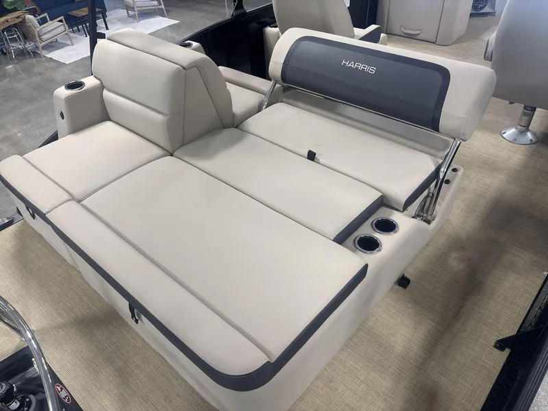 Slide: The Image of 2024 Harris Cruiser 210 boat interior with beige seating and cup holders. - 18