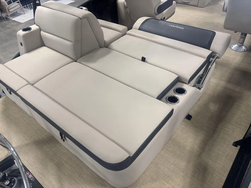 Slide: The Image of 2024 Harris Cruiser 210 boat interior with beige seating and cup holders. - 19