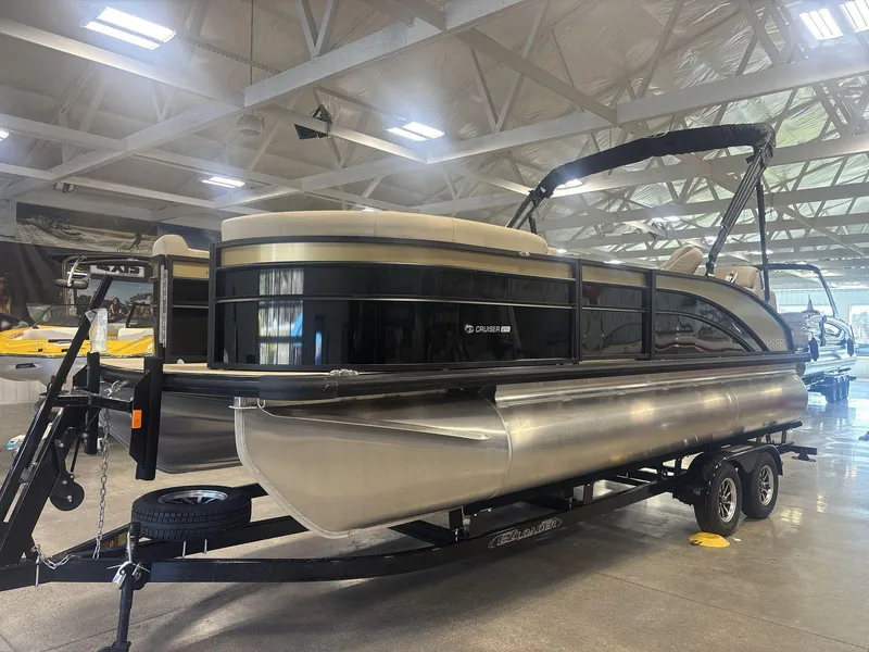 Slide: The Image of 2024 Harris Cruiser 210 pontoon boat on trailer in showroom. - 3