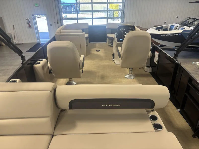Slide: The Image of 2024 Harris Cruiser 210 interior with beige seating and modern helm. - 7