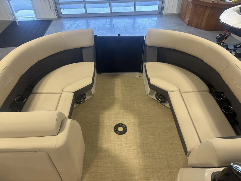 Slide: The Image of 2024 Harris Cruiser 210 interior with beige seating and cup holders. - 8