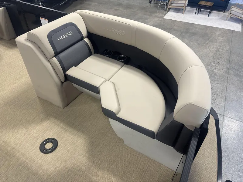 Slide: The Image of 2024 Harris Cruiser 210 boat seating with beige and gray upholstery, featuring cup holders. - 9