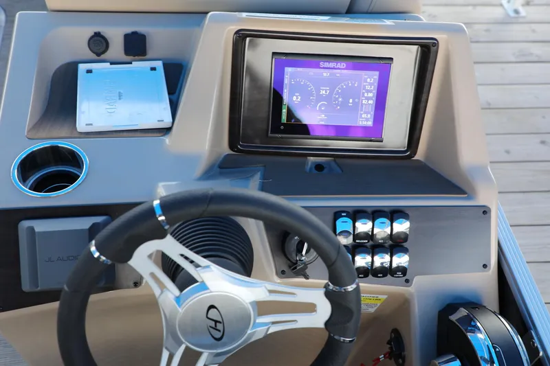 Slide: The Image of 2023 Harris Cruiser 230 dashboard with steering wheel and Simrad display. - 5
