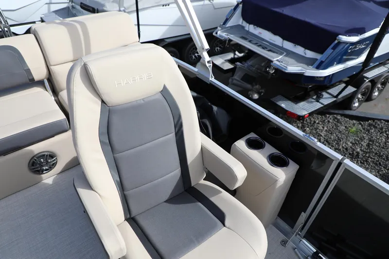 Slide: The Image of 2024 Harris Cruiser 230 boat interior with plush seating and cup holders. - 10