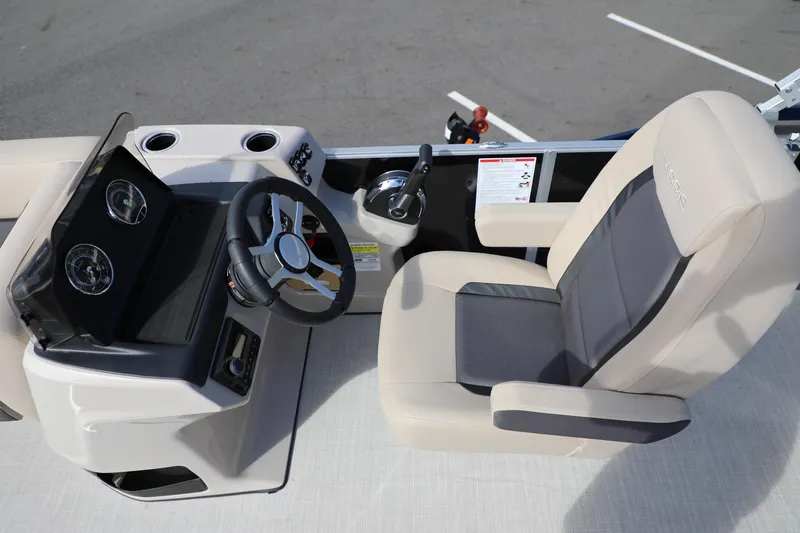 Slide: The Image of 2024 Harris Cruiser 230 boat helm with steering wheel and comfortable captain's chair. - 14