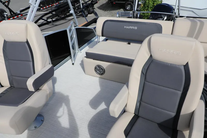 Slide: The Image of 2024 Harris Cruiser 230 boat interior with beige and gray seating. - 17