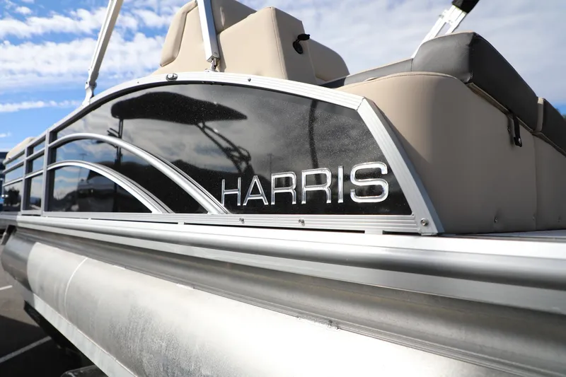 Slide: The Image of 2024 Harris Cruiser 230 pontoon boat with sleek design and comfortable seating. - 6