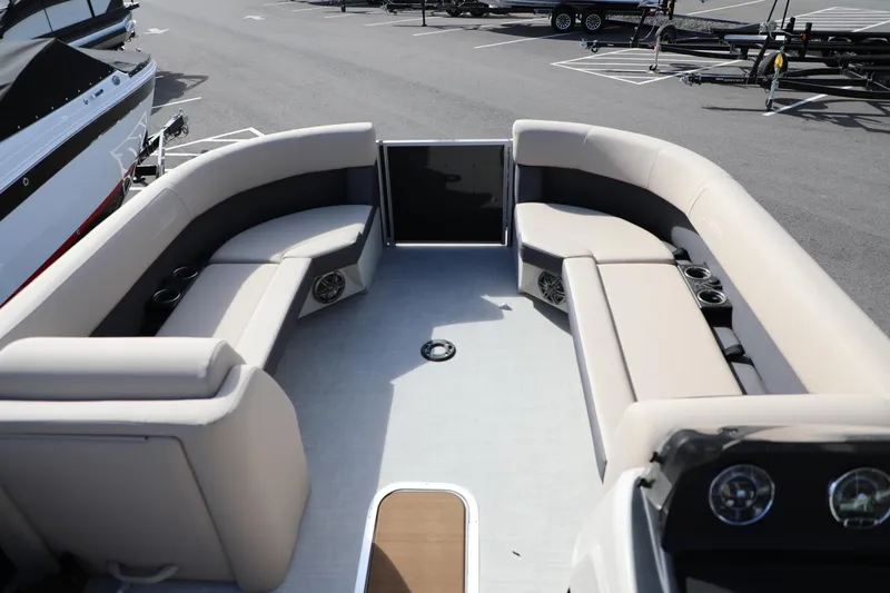 Slide: The Image of 2024 Harris Cruiser 230 boat interior with beige seating and cup holders. - 8